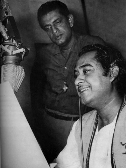 Kishore Kumar, and behind him Satyajit Ray